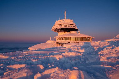 sunset on Sniezka mountain during winter in Karkonosze Poland clipart