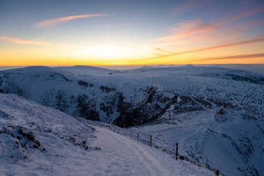 amazing winter landscape of Karkonosze mountains during sunset in Poland and Czech republic  clipart