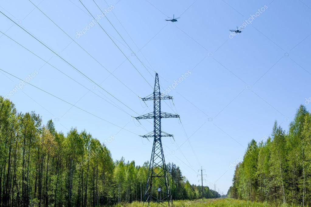 High voltage transmission line pass through the forest — Stock Photo