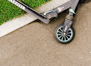 Tekme scooter yolun kenarında yatıyor.