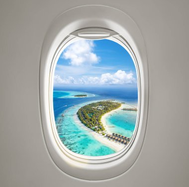 Muhteşem bir turkuaz plaj manzarası ve bir uçak lombozundan görünen el değmemiş sahil şeridi.