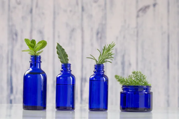 Essential oils  in blue bottles — Stock Photo, Image