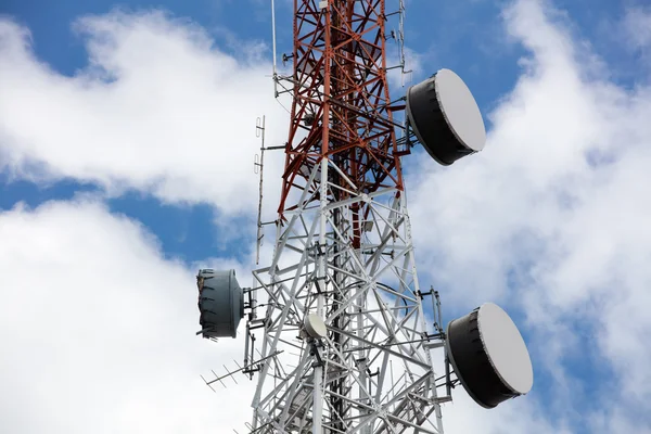 Close up antenna repeater tower on blue sky.