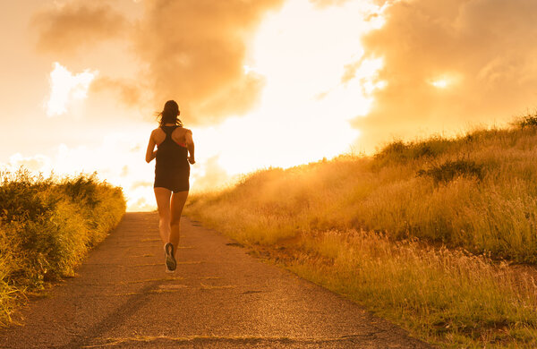 Female running at sunset. 