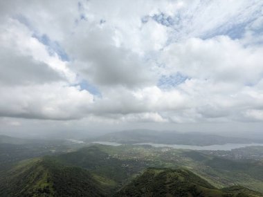 Muson mevsiminde yeşil tepelerin panoramik görüntüsü Sahyadris 'teki manzaranın üzerinde kara bulutlar beliriyor..