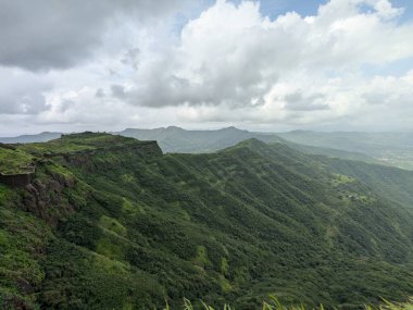 Muson mevsiminde yeşil tepelerin panoramik görüntüsü Sahyadris 'teki manzaranın üzerinde kara bulutlar beliriyor..