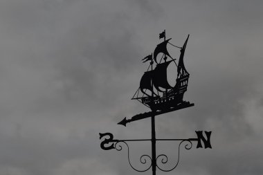 Silhouette of an Antique Ship Themed Weather Vane clipart