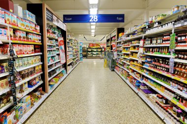 Aisle view of a Tesco supermarket clipart
