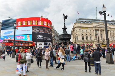 Tourists visit the landmark Piccadilly Circus clipart