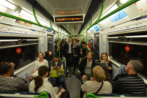 People board and disembark a Victoria Line underground