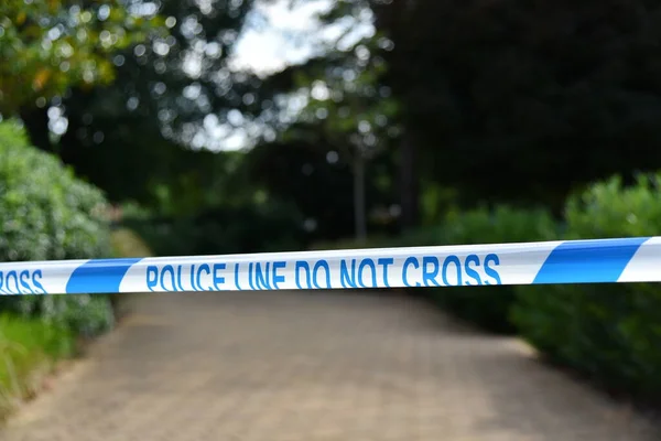 View of Police Cordon Tape Blocking at Street at a Crime Scene