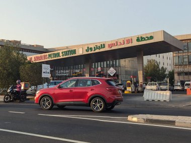 14 Haziran 2025 tarihinde Katar 'ın Doha kentinde bir şehir merkezi yolunda bir benzin istasyonu görülmektedir. Orta Doğu ülkesi ham petrolü, El Endülüs gibi istasyonlarda satılan petrole dönüştürmesine karşın, rafine etmek Katar 'ın LNG doğalgaz üretimiyle karşılaştırıldığında daha mütevazı kalıyor..