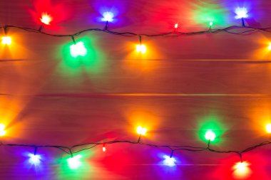 ahşap arka plan üzerinde renkli Noel ışıkları