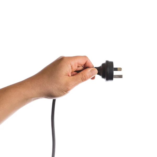 Рука держит черный электрический кабель — стоковое фото