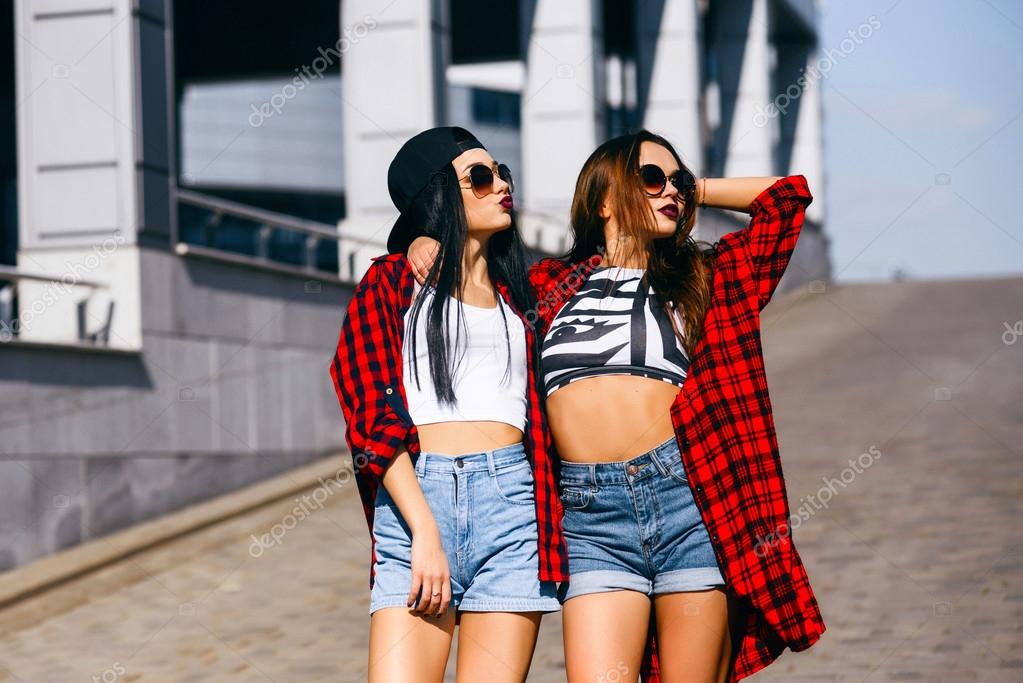 Two young happy hipster girls in sunglasses having fun, smiling, laughing,  jumping, walking outdoor on the street, summer relax concept Stock Photo by  ©isdvsk.gmail.com 111732746