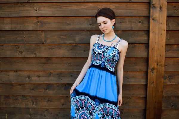 Young beautiful girl in blue dress posing outdoor at the sunset — Stock Photo, Image