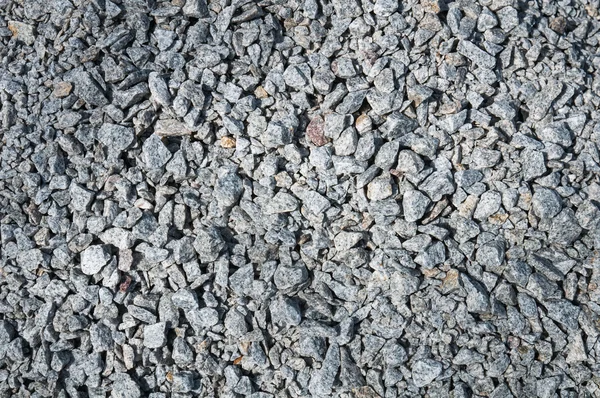 Hintergrund aus vielen kleinen Steinen — Stockfoto
