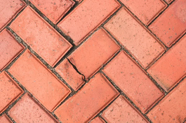 Vieille chaussée en brique rouge altérée, texture de fond en gros plan — Photo