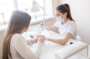 Güzellik salonunda manikür. Manikür yapan kadın.