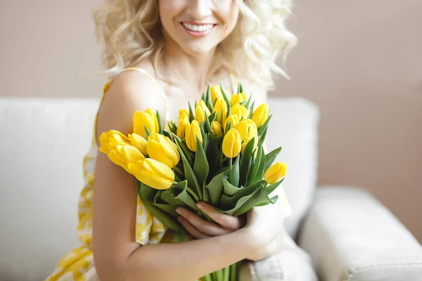美丽的金发女人 带着一束黄色郁金香 — 图库照片