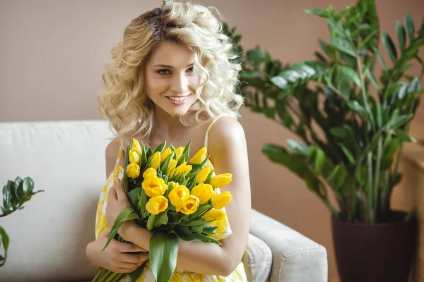 美丽的金发女人 带着一束黄色郁金香 — 图库照片