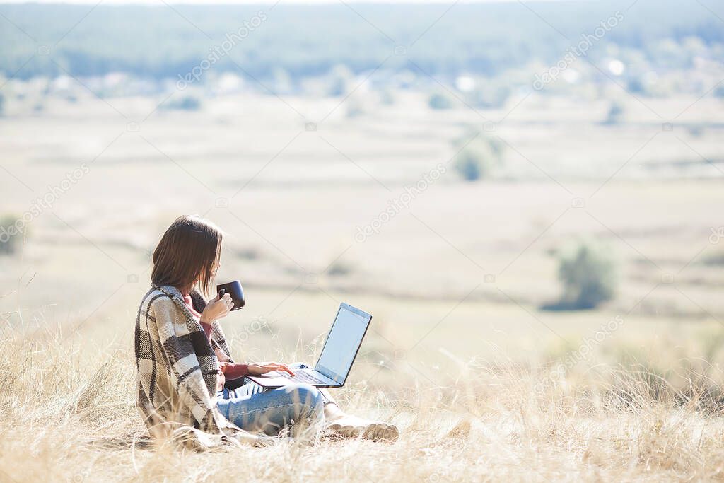 Woman woking outdoors. Remote work on camping. Female typing on pc.