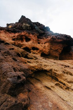 Layered geological formations display vibrant colors and textures, highlighting the beauty of rocky terrain and the intricate details of natural landscapes