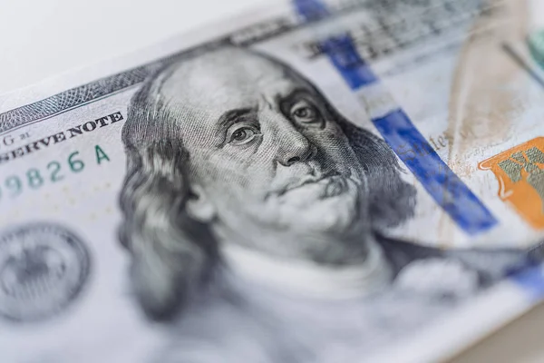 Portreyi, güvenlik unsurlarını ve canlı renkleri vurgulayan, zenginlik ve ekonomik işlemleri sembolize eden 100 dolarlık banknotun ayrıntılı görüntüsü