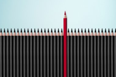 Red pencil standing out from crowd