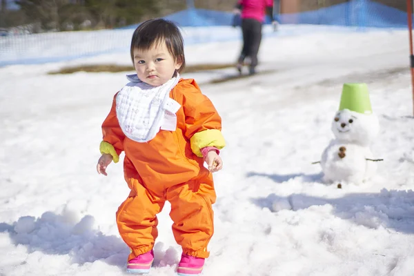 Adorable baby plays with snow — Stock Photo, Image