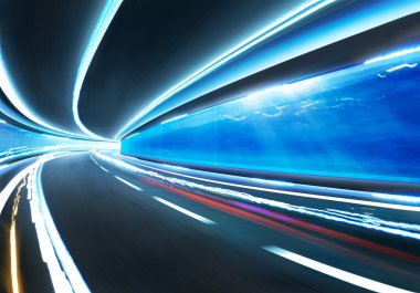 Speed motion road  in glass tunnel clipart