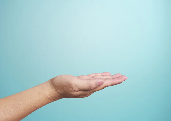 Human hand on  blue background — Stock Photo, Image
