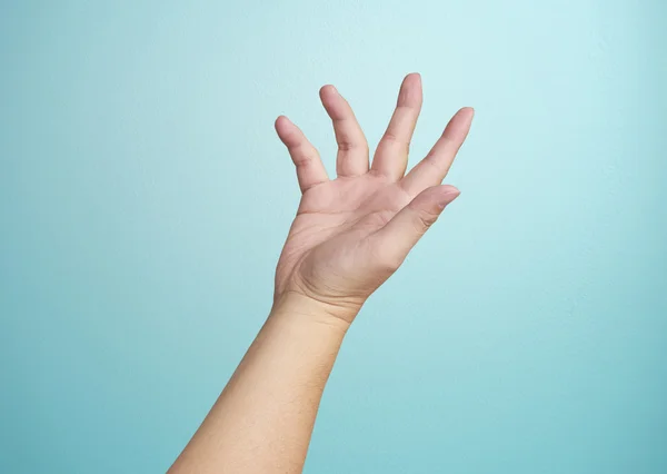 Human hand on  blue background — Stock Photo, Image