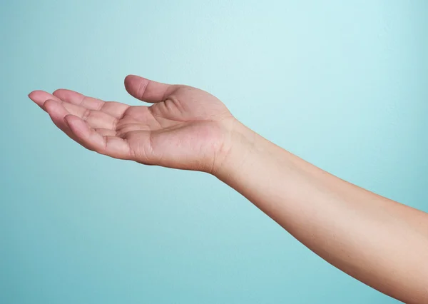 Human hand on  blue background — Stock Photo, Image