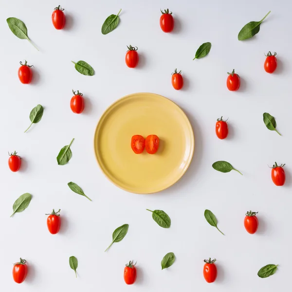 Cherry tomatoes and basil leaves pattern. — Stock Photo, Image