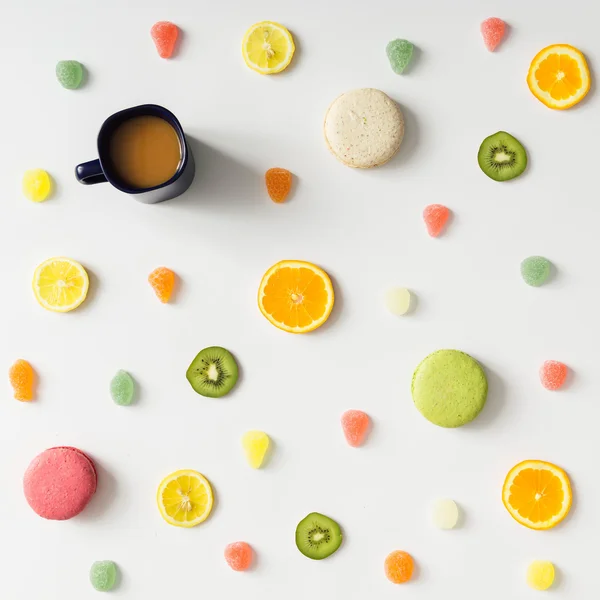 Colorful bright fruit pattern with coffee mug and sweets on whit — Stock Photo, Image