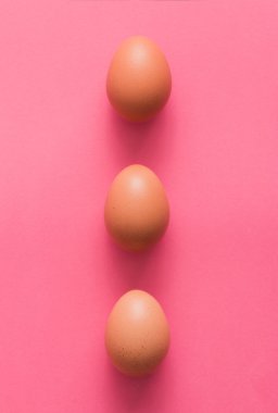 Three eggs on pink background clipart