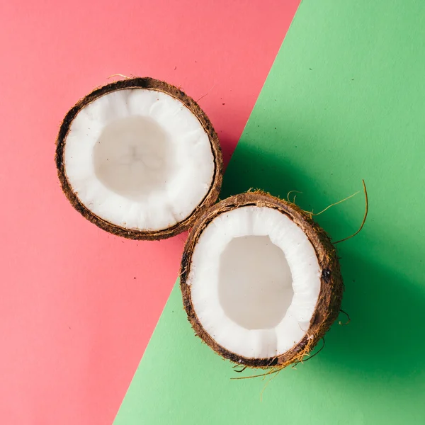 Coconut on pink and green background — Stock Photo, Image