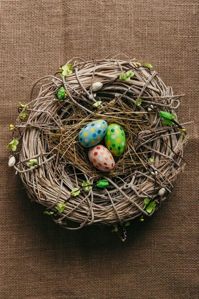 Colorful Easter eggs in bird nest — Stock Photo, Image