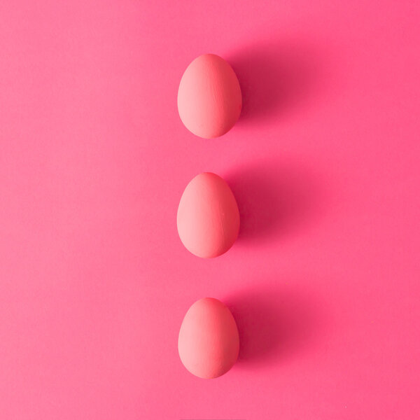 Three eggs on pink background