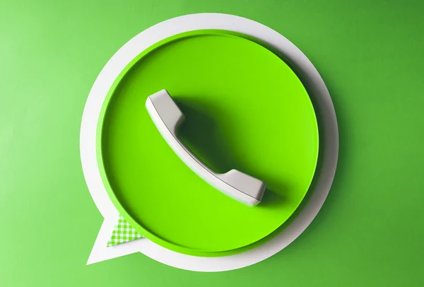 Green phone handset in speech bubble icon made of everyday objec — Stock Photo, Image