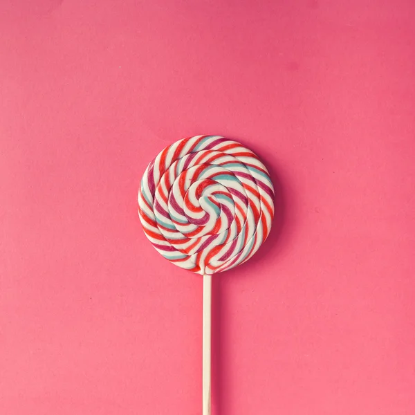 Colorful lollipop on pink background. — Stock Photo, Image