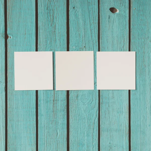 Three blank photos on wooden background — Stock Photo, Image