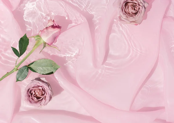 絹織物で水にピンクのバラの花 バレンタインデーと女性の日の背景デザイン 最小限の平らな自然 — ストック写真