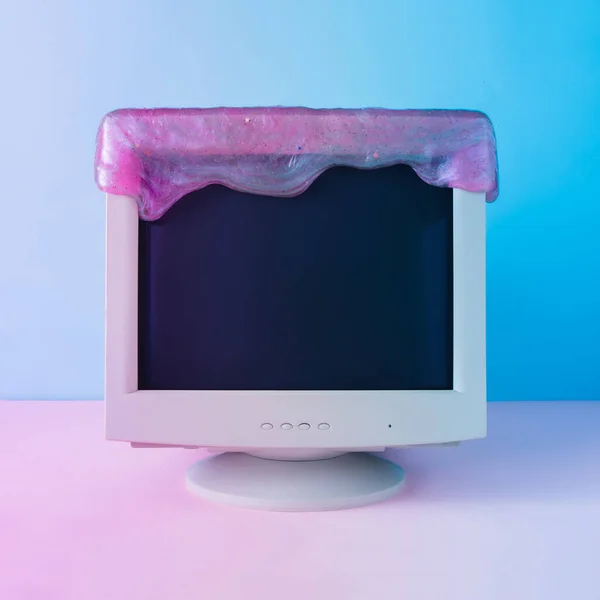 Retro vintage computer monitor with glitter slime. Blue and purple colored lights. Creative minimal cyberwave background. Retro futurism.