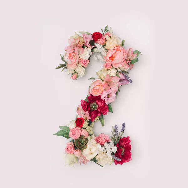 Number 2 made of real natural flowers and leaves. Flower font concept. Unique collection of letters and numbers. Spring, summer and valentines creative idea.