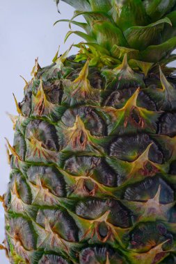 Egzotik Meyve Yakın plan: Beyaz üzerine izole edilmiş ananas pulları ve yaprakların dokusu. Yüksek kalite fotoğraf