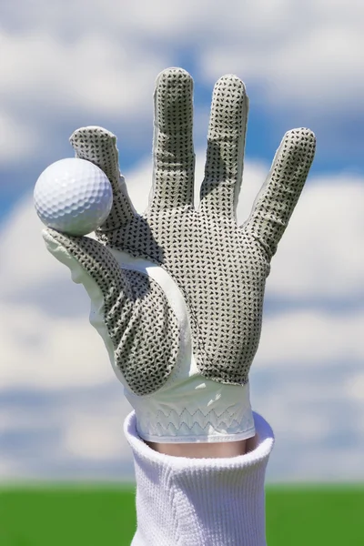 Glove with golf ball — Stock Photo, Image