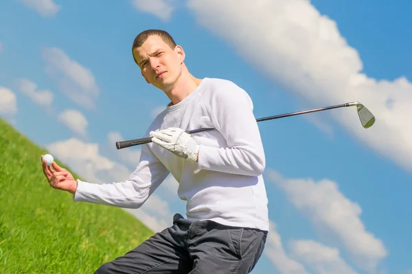 No campo, o golfista segura a bola — Fotografia de Stock