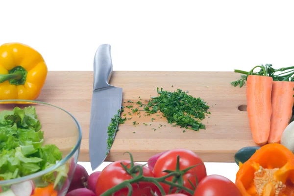 Chopped greens surrounded by fresh vegetables — Stock Photo, Image